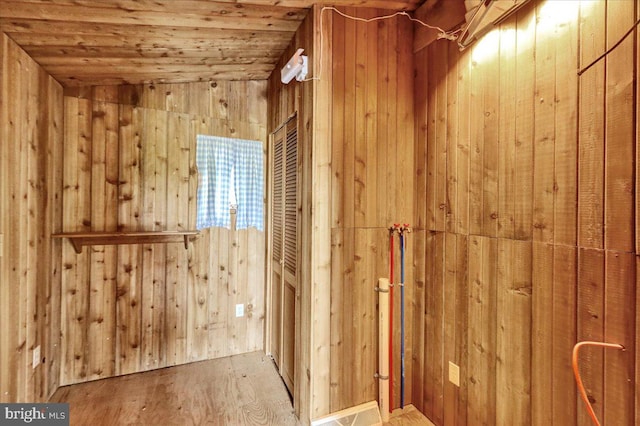 bathroom featuring hardwood / wood-style flooring, wooden ceiling, wooden walls, and vaulted ceiling