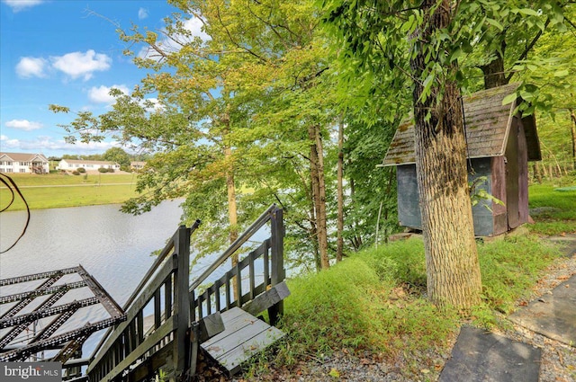 exterior space with a water view and a dock