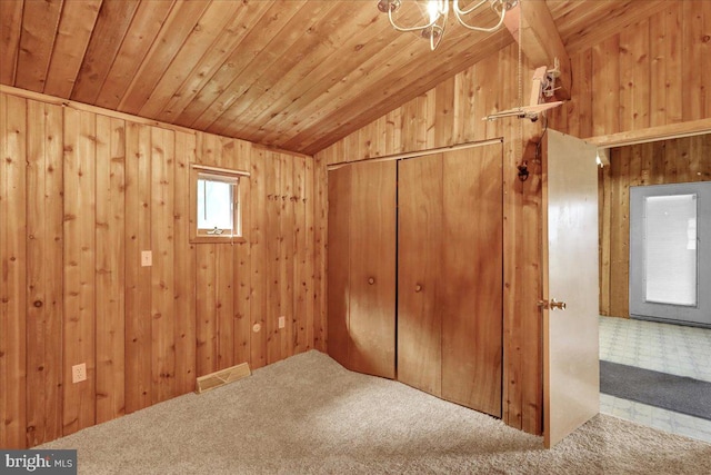 interior space with wood walls, wood ceiling, and vaulted ceiling