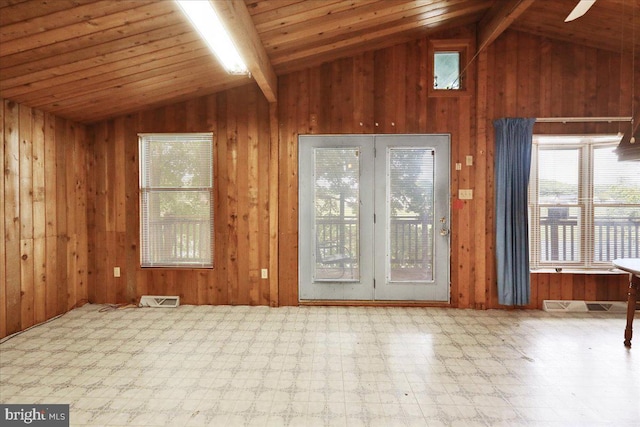 doorway to outside featuring vaulted ceiling with beams, wooden ceiling, and wood walls