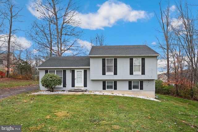 split level home featuring a front lawn