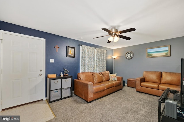 carpeted living room with ceiling fan