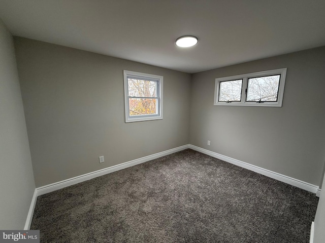 empty room with dark carpet