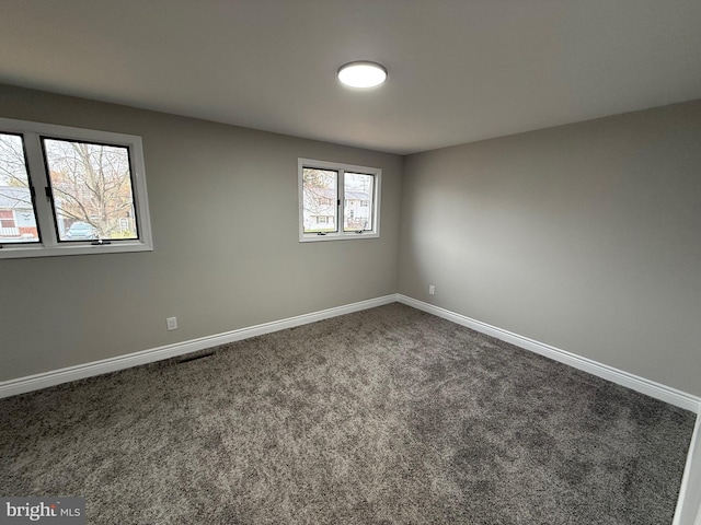 unfurnished room with plenty of natural light and carpet floors