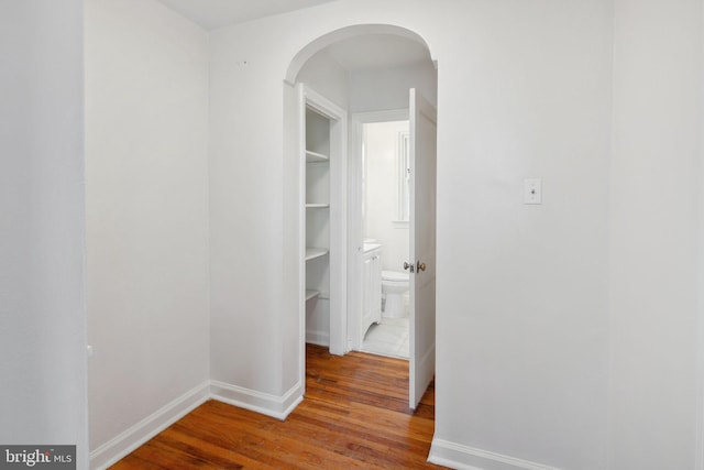 corridor featuring wood-type flooring