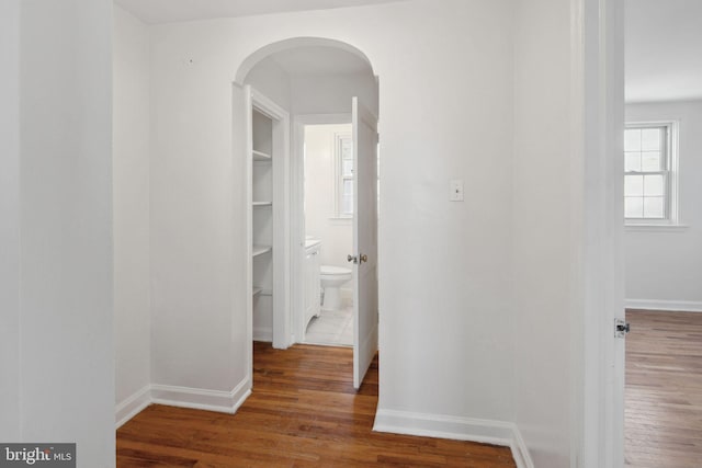 hallway with dark hardwood / wood-style flooring