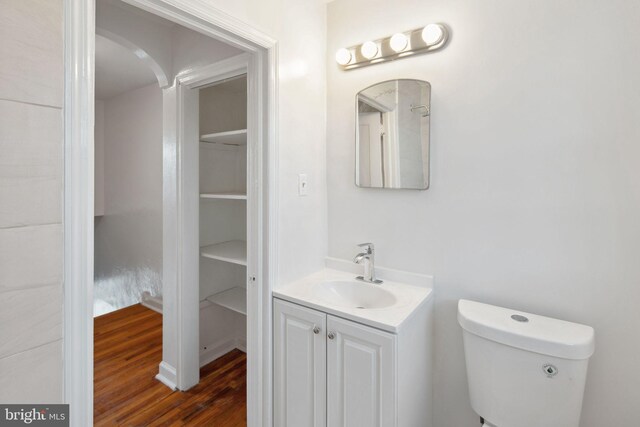 bathroom featuring vanity, hardwood / wood-style flooring, and toilet