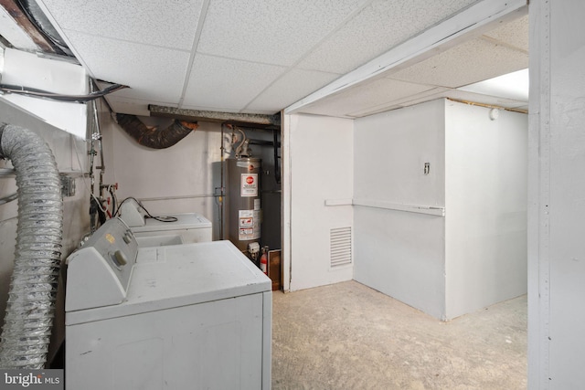 laundry area featuring washer and dryer, light colored carpet, and water heater