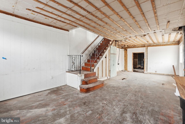 basement featuring wood walls