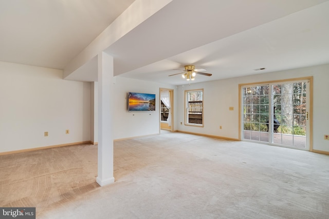 unfurnished living room with ceiling fan, a healthy amount of sunlight, and light colored carpet