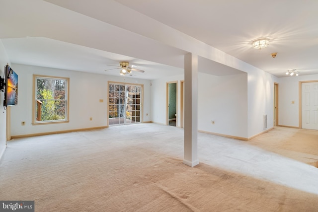 carpeted spare room with ceiling fan