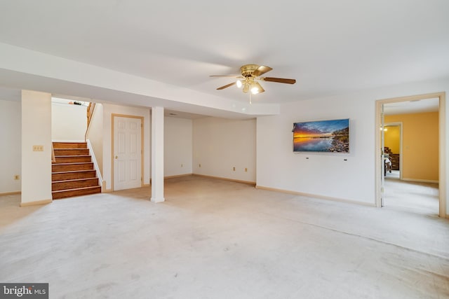 basement featuring ceiling fan and light colored carpet