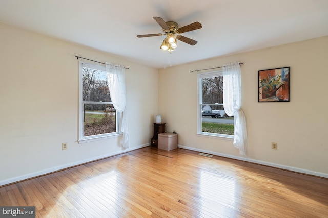 spare room with ceiling fan and light wood-type flooring