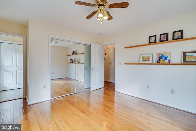 unfurnished bedroom featuring hardwood / wood-style flooring and ceiling fan