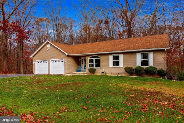 ranch-style home featuring a front lawn and a garage