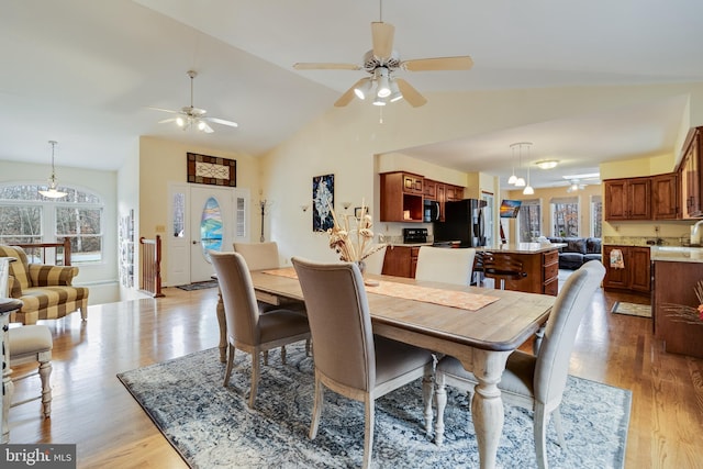 dining area featuring french doors, high vaulted ceiling, light hardwood / wood-style flooring, and ceiling fan