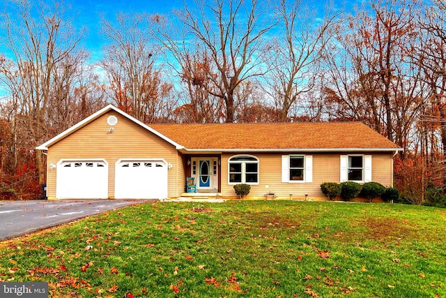 ranch-style house with a garage and a front lawn