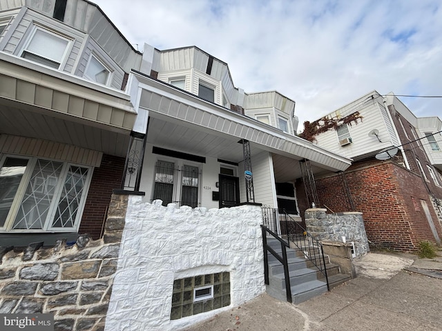 view of side of home with a porch