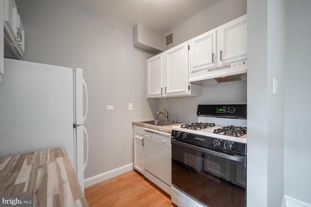 kitchen featuring white appliances, premium range hood, sink, light wood-type flooring, and white cabinetry