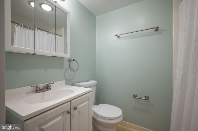 bathroom with walk in shower, tile patterned flooring, vanity, and toilet