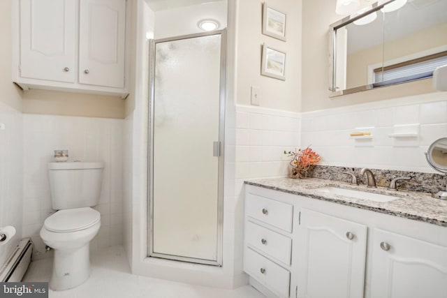 bathroom with vanity, toilet, baseboard heating, walk in shower, and tile walls