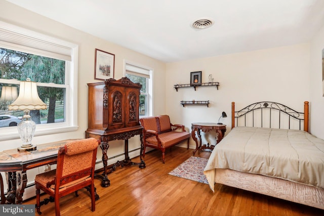 bedroom with hardwood / wood-style flooring