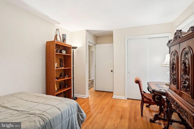 bedroom featuring a closet and light hardwood / wood-style flooring