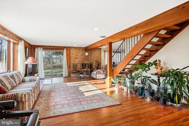 living room featuring light hardwood / wood-style floors and a brick fireplace