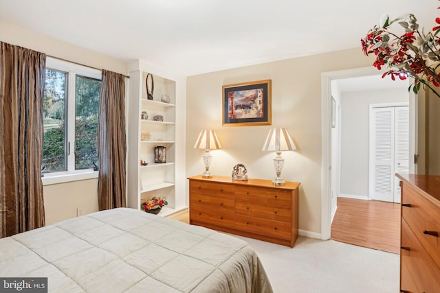 bedroom with light carpet and a closet