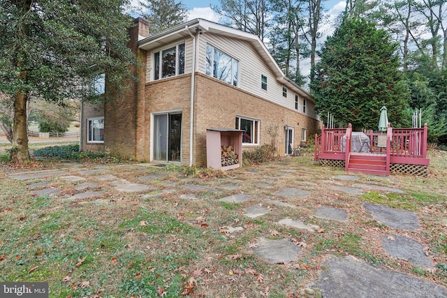 back of house with a wooden deck