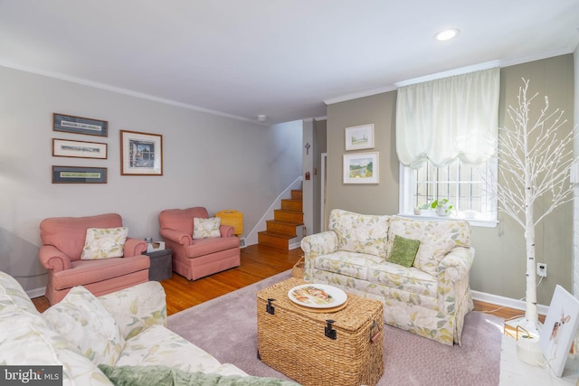 living room with light hardwood / wood-style floors and ornamental molding