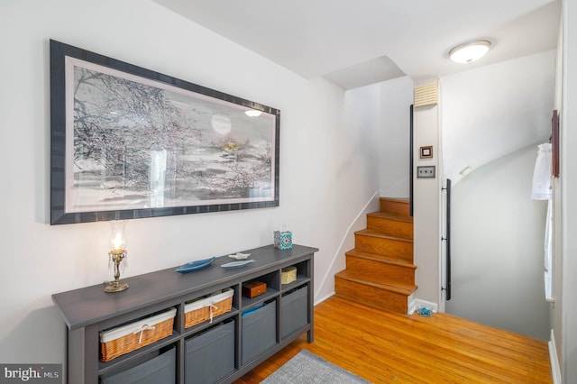 stairway featuring hardwood / wood-style floors