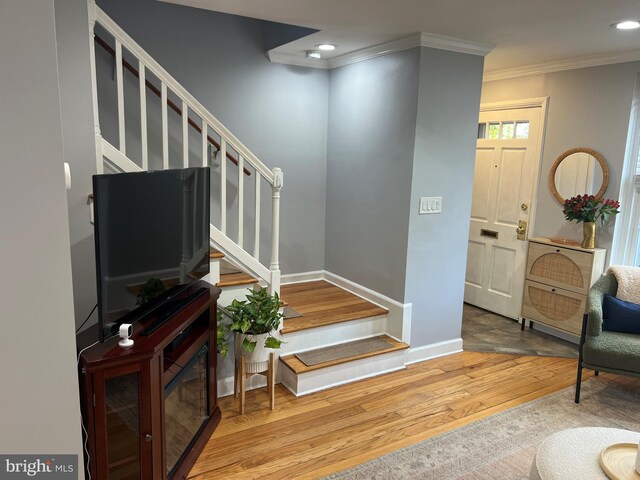 interior space featuring hardwood / wood-style floors and ornamental molding