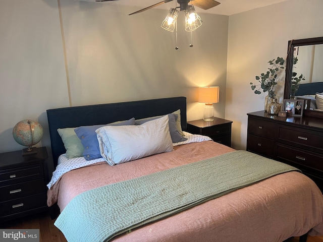 bedroom with ceiling fan and dark hardwood / wood-style floors