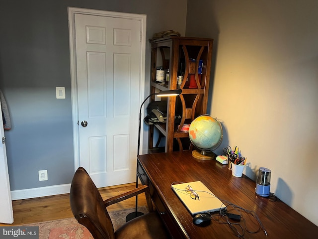 office space with wood-type flooring