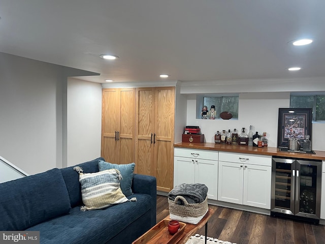 bar featuring butcher block countertops, wine cooler, dark hardwood / wood-style floors, and white cabinetry