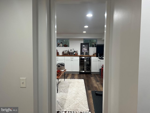 hallway with wine cooler and dark wood-type flooring