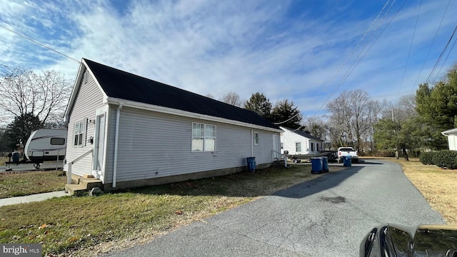 view of side of property with a yard