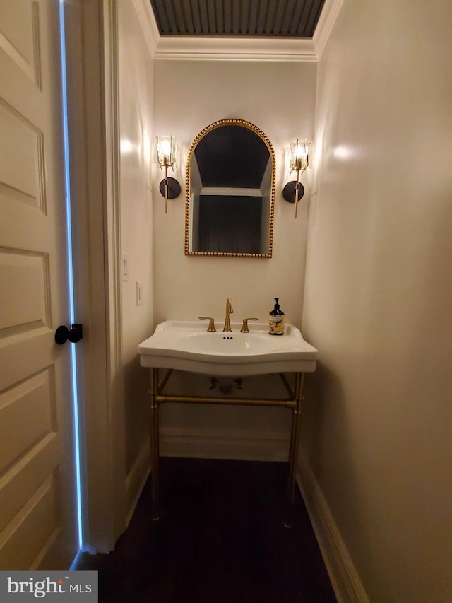 bathroom featuring crown molding and vanity