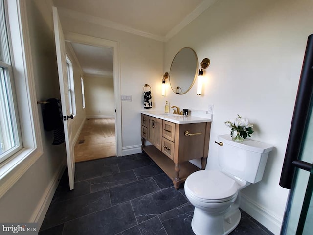 bathroom with vanity, toilet, and crown molding