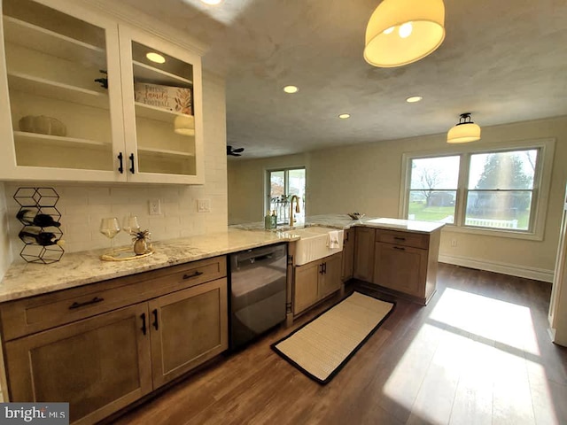 kitchen with sink, black dishwasher, tasteful backsplash, dark hardwood / wood-style flooring, and kitchen peninsula