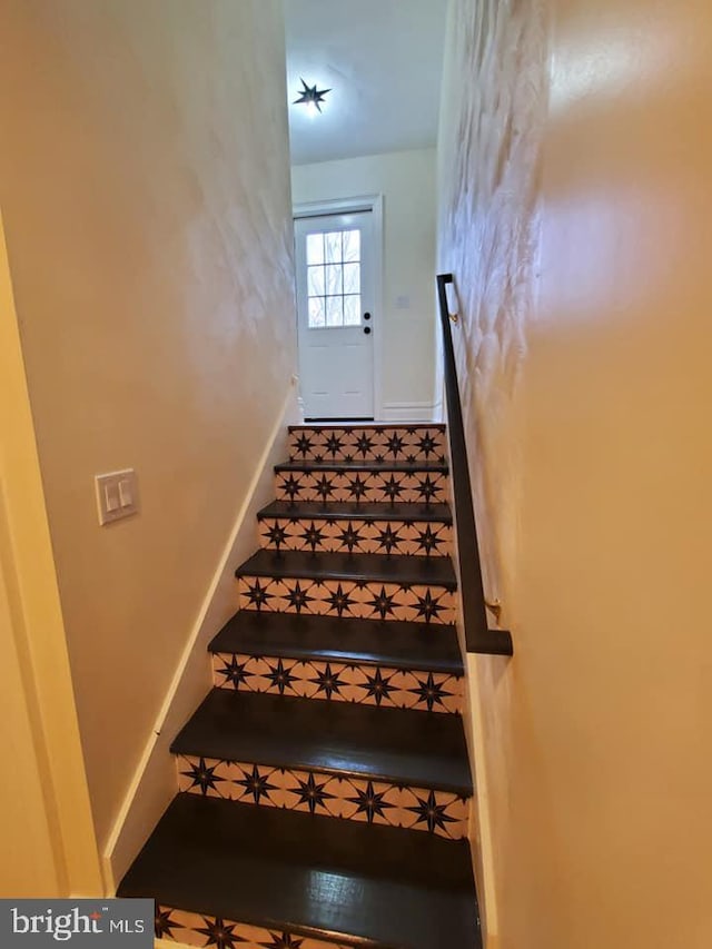 stairs featuring tile patterned floors