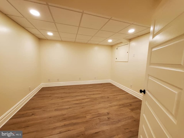 basement with wood-type flooring and a drop ceiling