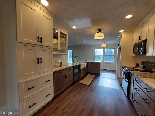 kitchen with kitchen peninsula, light stone counters, black appliances, white cabinets, and dark hardwood / wood-style floors