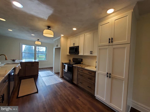 kitchen with dark hardwood / wood-style flooring, light stone counters, black appliances, pendant lighting, and white cabinetry