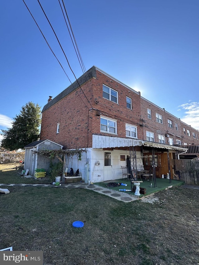 rear view of property with a patio area and a yard