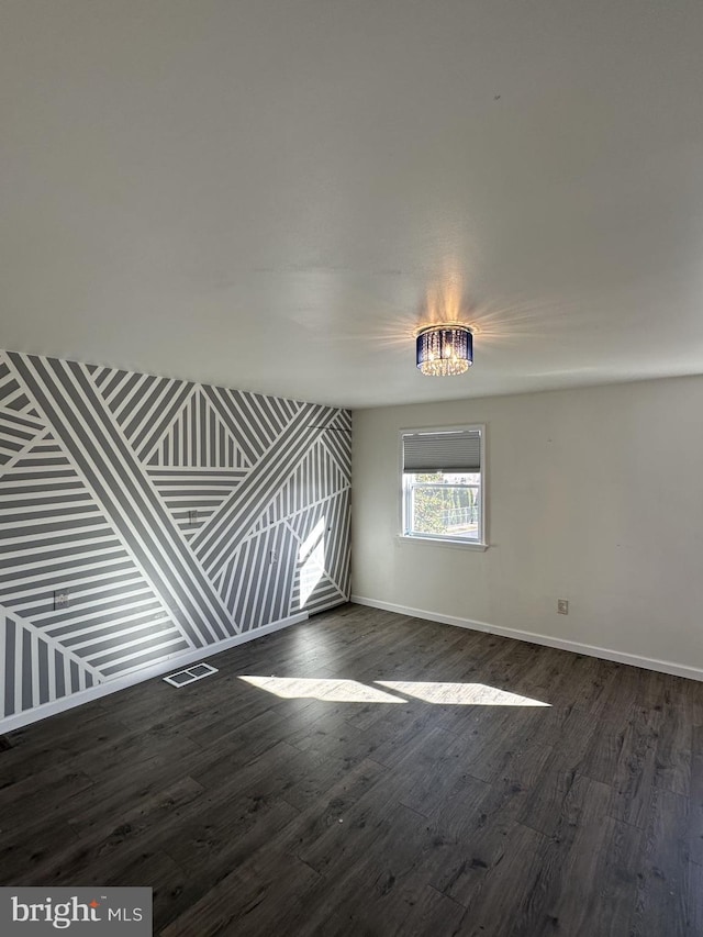 unfurnished room featuring dark hardwood / wood-style flooring