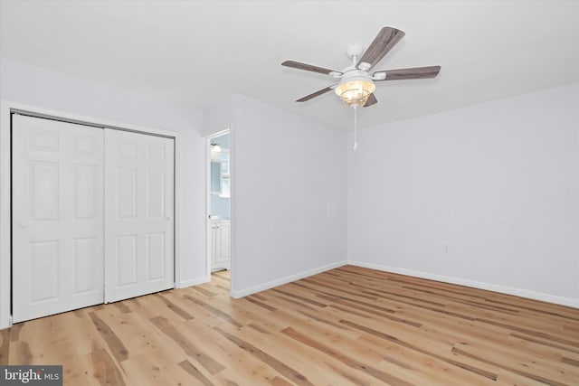 unfurnished bedroom with ceiling fan, a closet, and light wood-type flooring