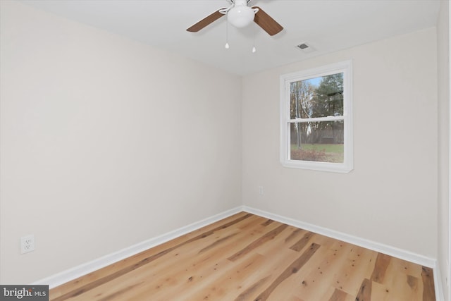 empty room with hardwood / wood-style flooring and ceiling fan