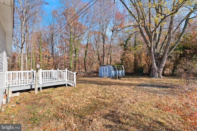 view of yard featuring a shed and a deck